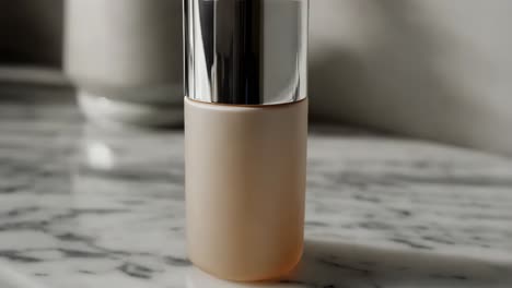 beige cosmetic bottle on marble countertop