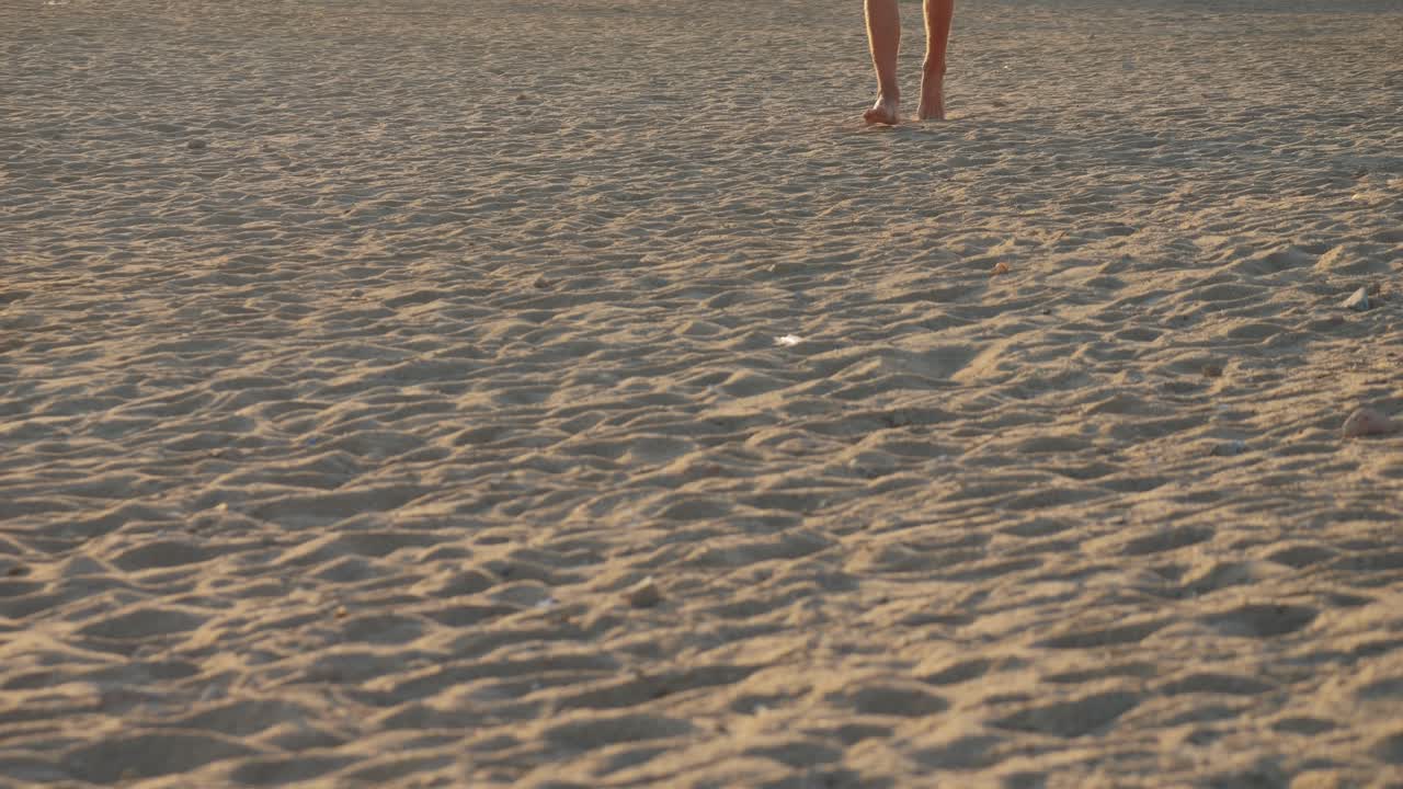 Barefoot walking on the beach at sunset