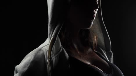 Muscular-woman-wearing-grey-hood-