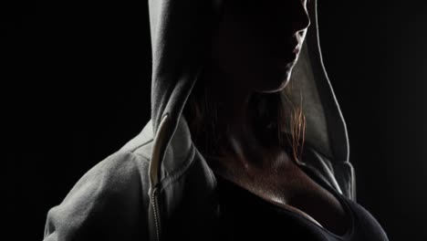 muscular woman wearing grey hood