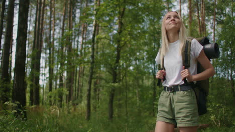 SLow-motion:-Traveling-Happy-Caucasian-woman-with-backpack-walking-on-path-the-tropical-forest