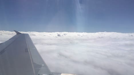 turbine view from an airplane flying close to white clouds in the sky