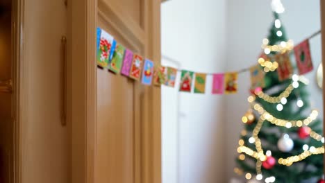 a christmas tree and garland decorated with gold and red ornaments