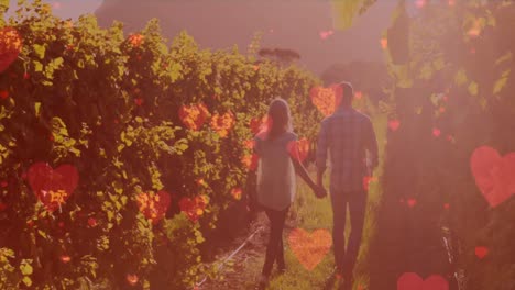 animación de corazones digitales sobre una pareja caucásica caminando por una plantación