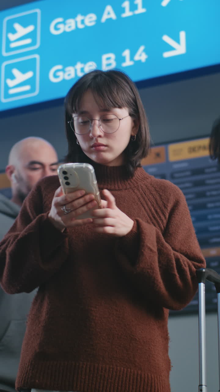 Woman using phone in airport