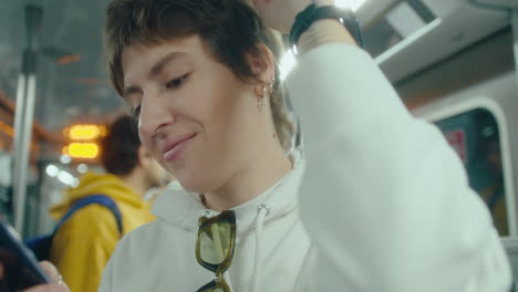 girl messaging on phone during metro ride