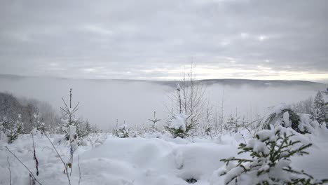 heavy fog is rolling over hills in beautiful winter landscape time lapse