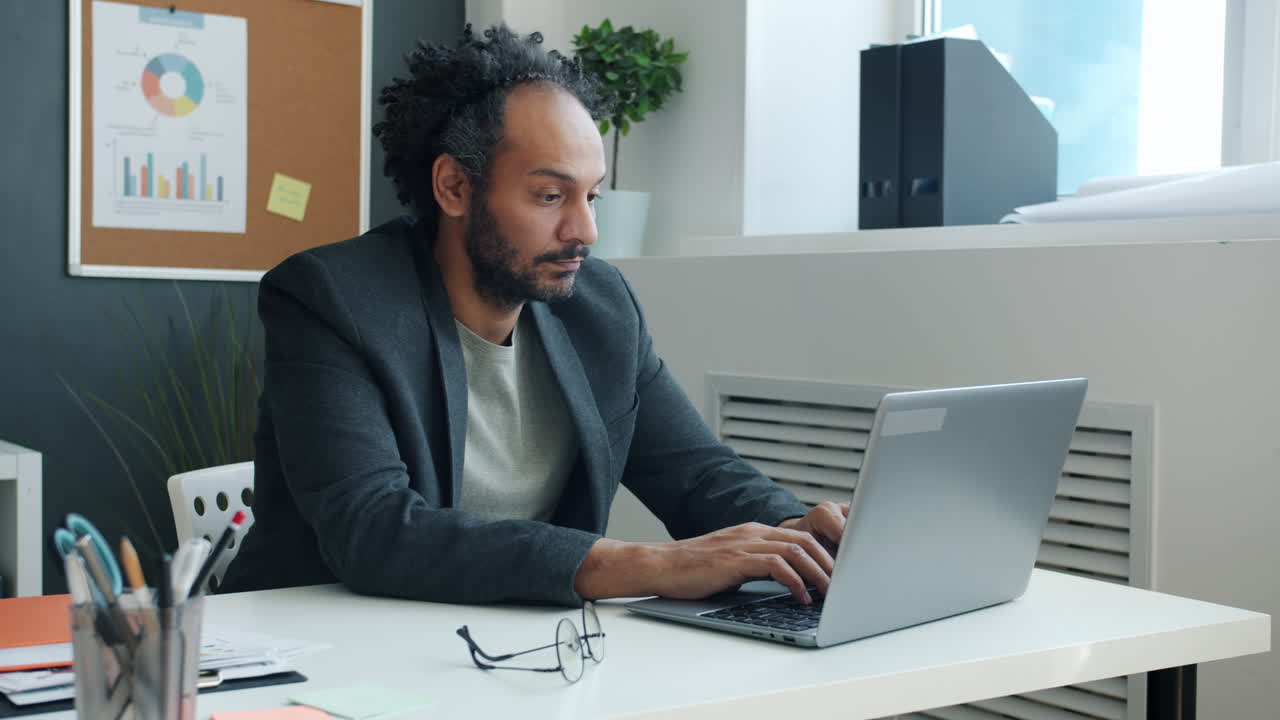 Man Working on Laptop in Office