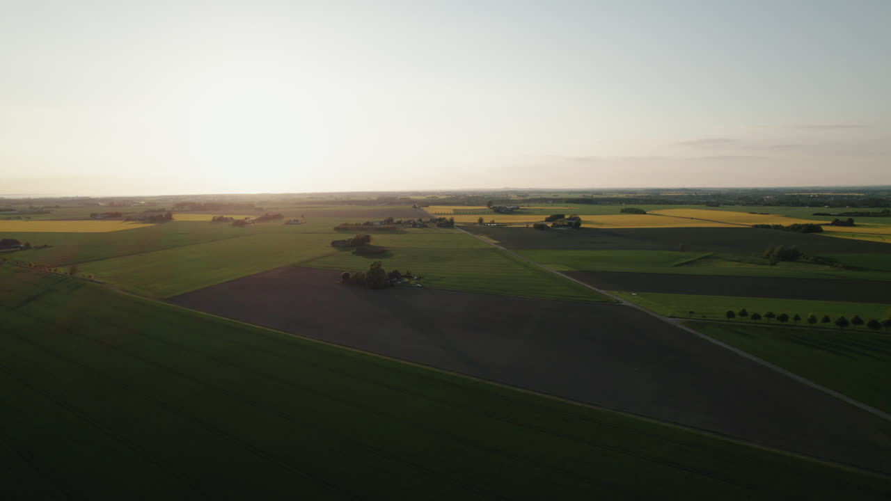 Countryside landscape, Skåne, Sweden, aerial in sunset, golden hour