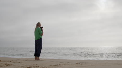 woman with dog on a beach