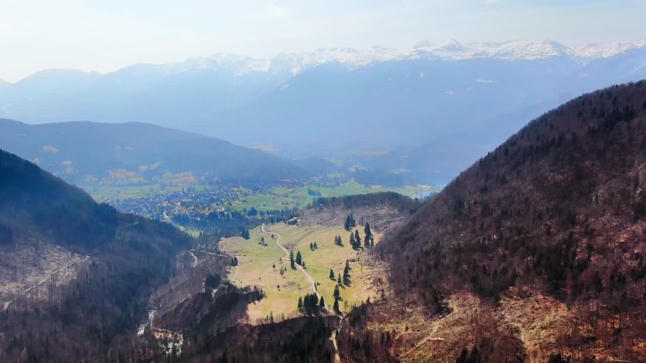 Cinematic aerial shot revealing Bohinj lake on a misty autumnal day in Triglav National Park, Slovenia