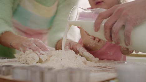 Handheld-view-of-little-girl-making-cookies-with-parents