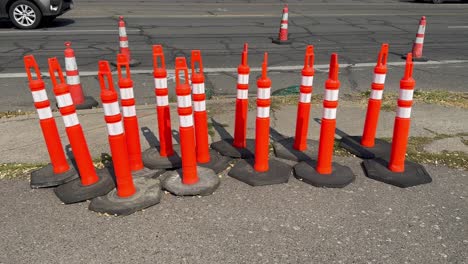 group of safety cones on the side of an asphalt road