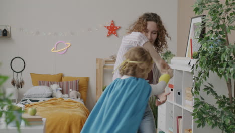 mother and child playing superhero