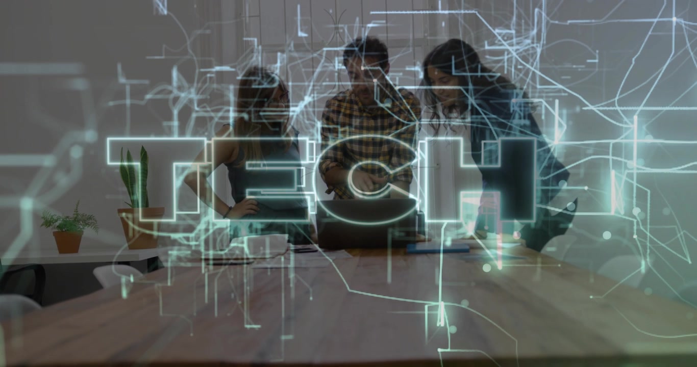 Colleagues leaning over laptop reviewing tech data, initiating holographic lines forming TECH logo