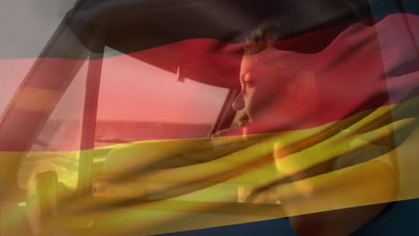 Animation-of-german-flag-over-thoughtful-african-american-woman-looking-through-vehicle-window