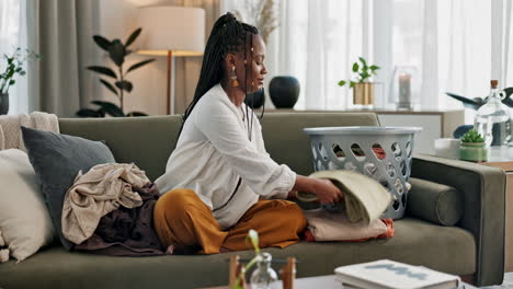 Laundry,-housework-and-a-black-woman-folding