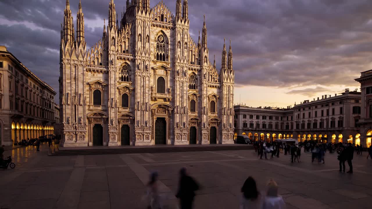 Wide-angle shot of Milan Cathedral at dusk, capturing its Gothic architecture and bustling square