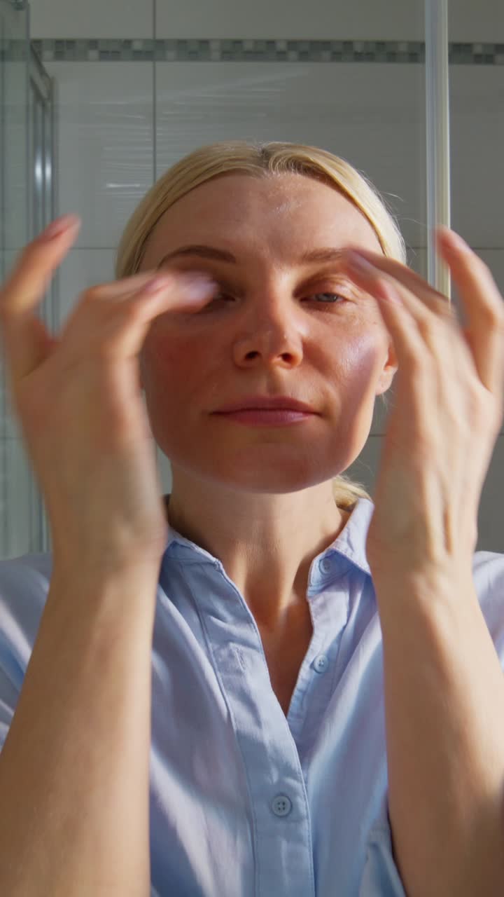 Woman applying face cream