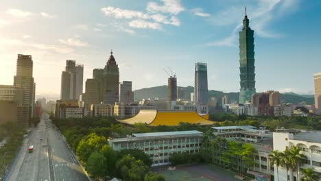 cinematic aerial shot showing sun yat-sen memorial hall and silhouette of skyscraper towers in taipei city during sunset