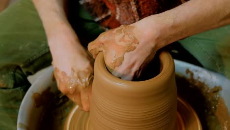 professional male potter working in workshop