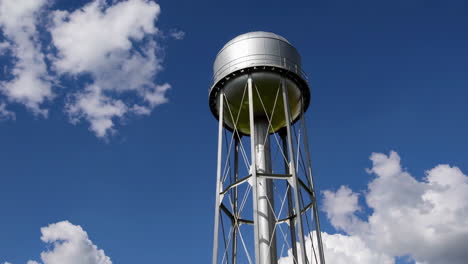 water tower against a blue sky with clouds