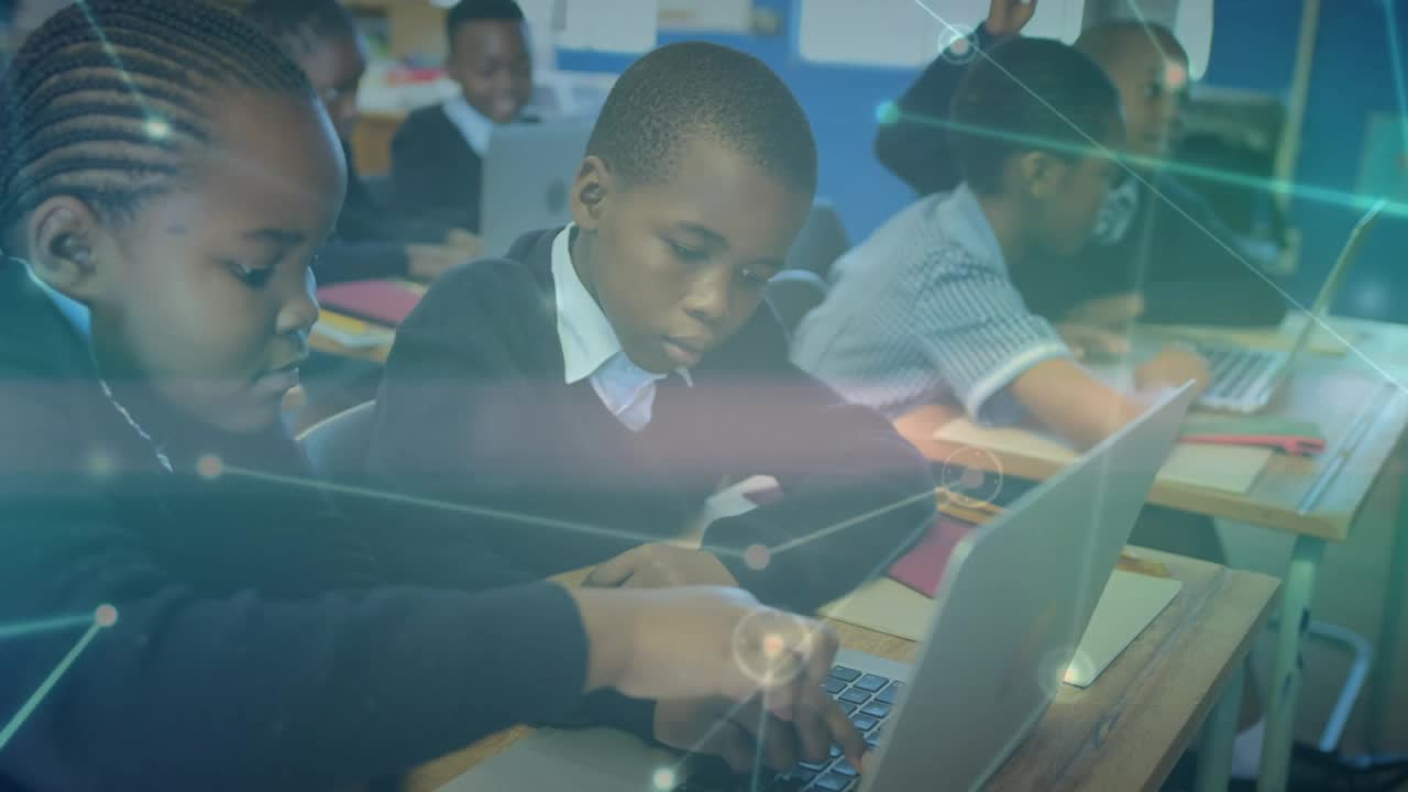 Front-row students typing and writing as network overlay intensifies for digital lesson
