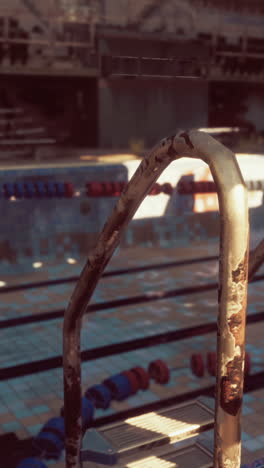 rusty metal ladder in an abandoned swimming pool