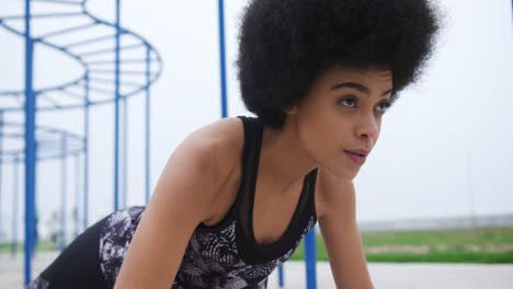 Mixed-race-woman-working-out-on-docks