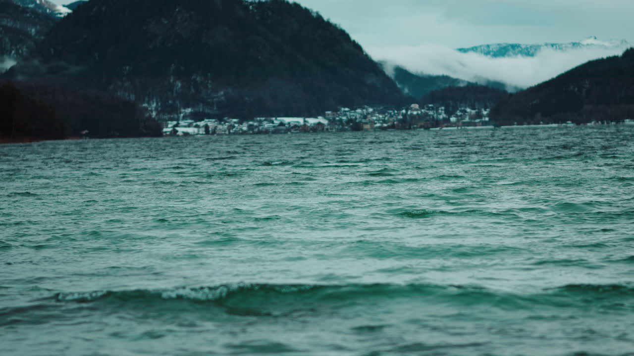 Winter Landscape of a Lake with Mountains and Town