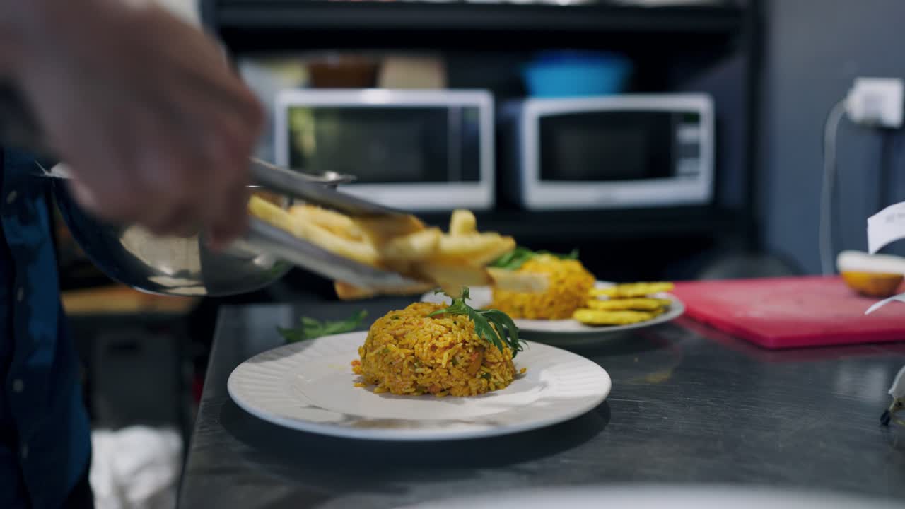 Chef Plating a Delicious Meal of Rice and French Fries