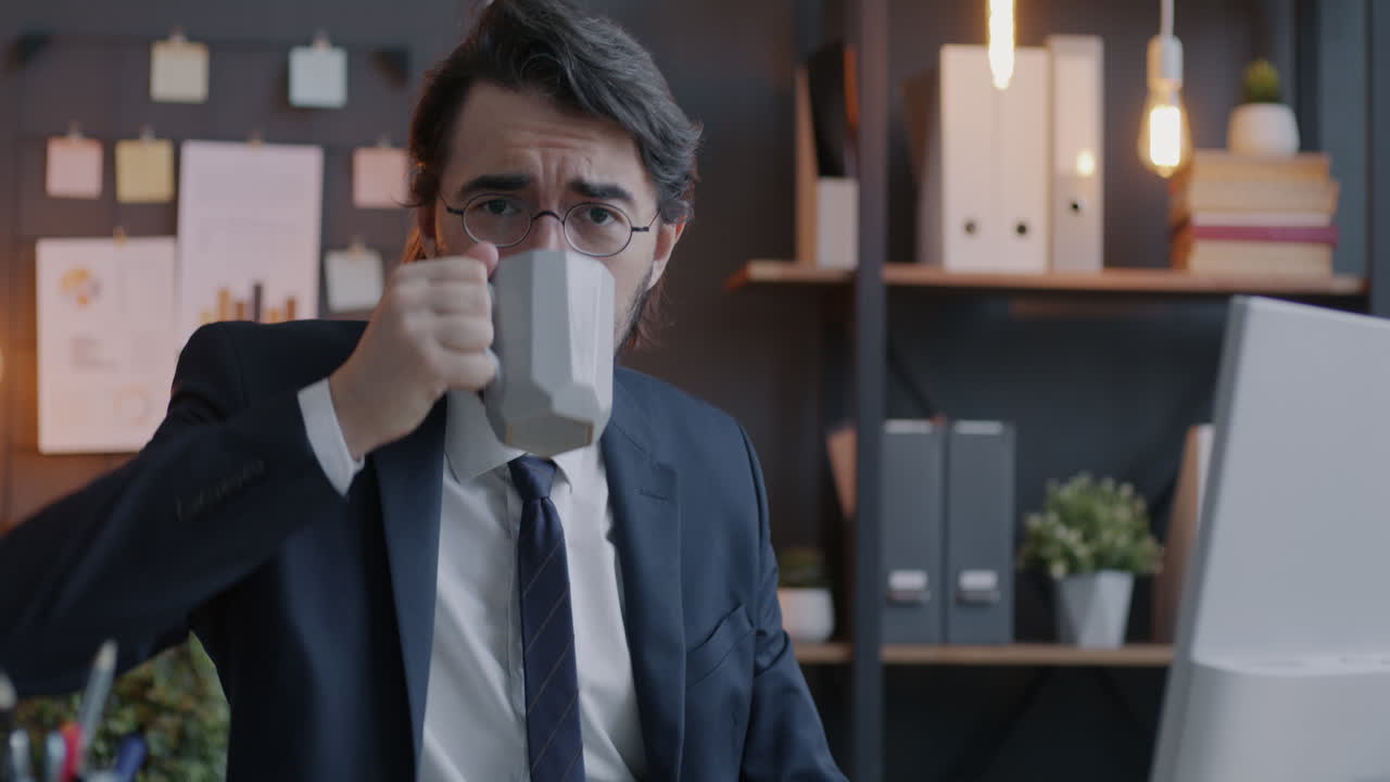 Businessman Drinking Coffee in Office