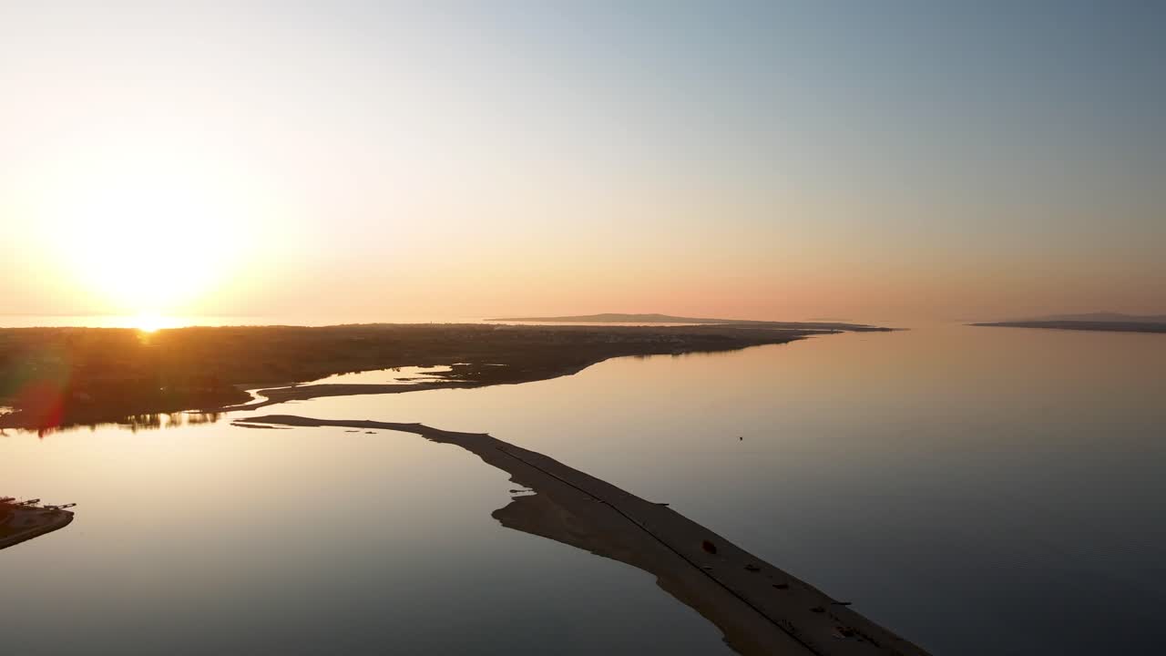 Drone flight over the sea Plaza Ninska laguna in Croatia city Nin at sun set