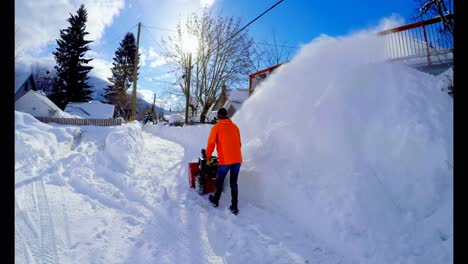 man clearing snow with snow blower 4k