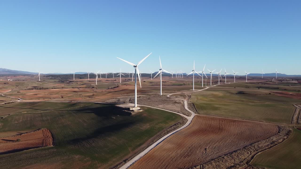 Windmills in field on sunny day