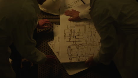 engineers reviewing technical drawings