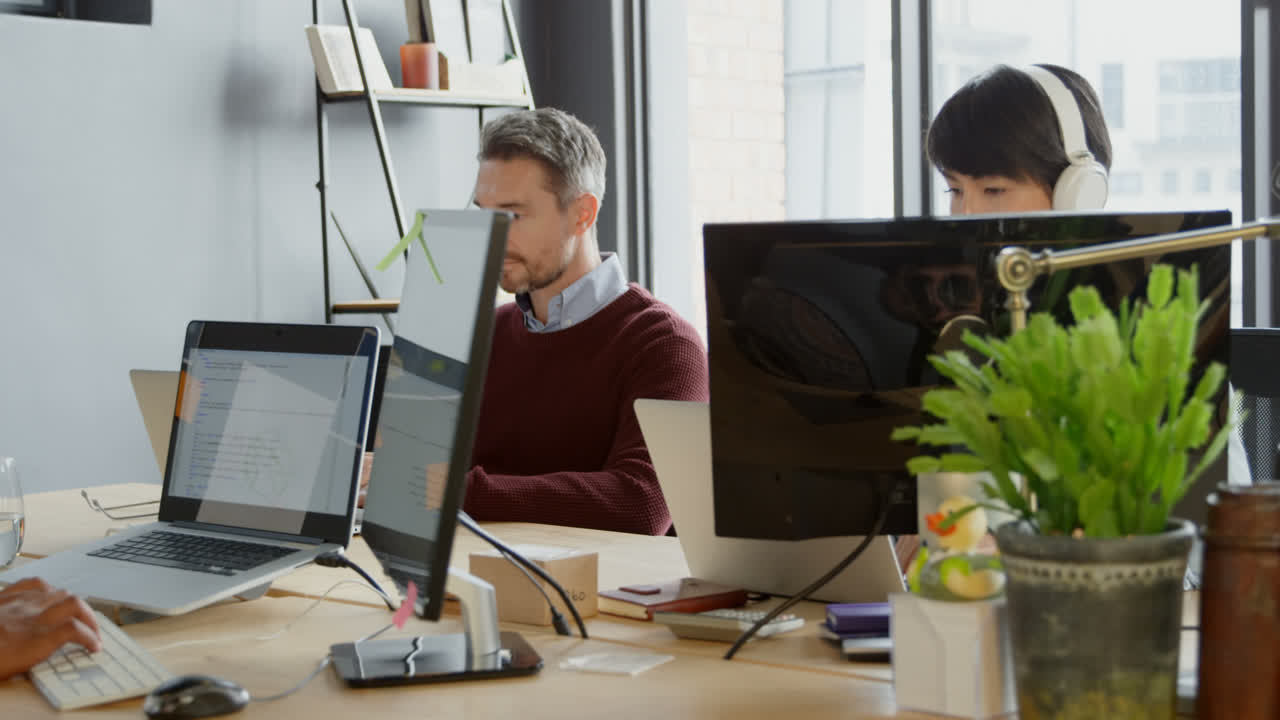 Business people interacting with each other in office 4k