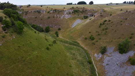 Aerial-view-flying-between-valley-in-picturesque-Peak-district-trekking-countryside