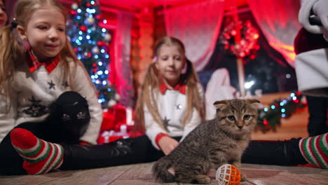family with santa claus at home. family sitting in the living room having fun with santa claus