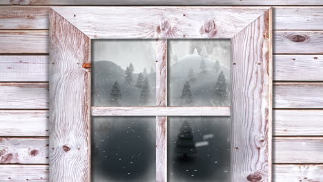 holzfensterrahmen gegen schnee, der über mehrere bäume in der winterlandschaft fällt