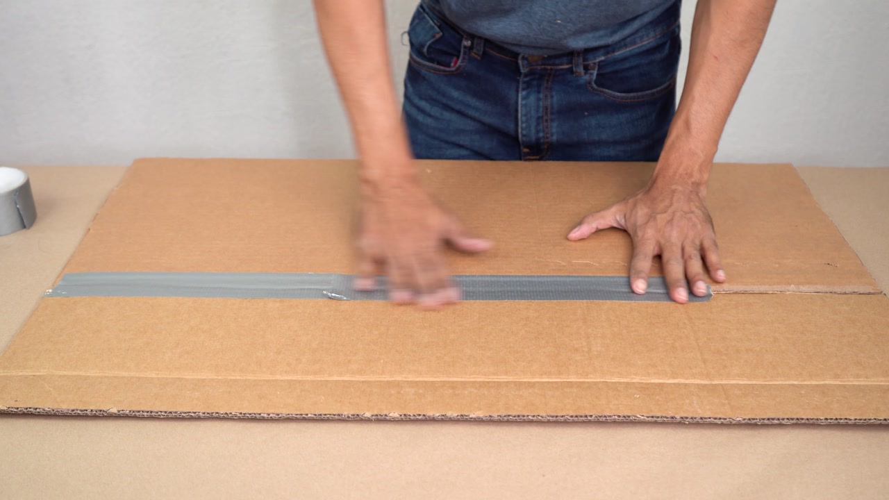 Duck taping cardboard box together