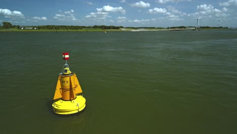 yellow buoy bobbing back and forth in the river current