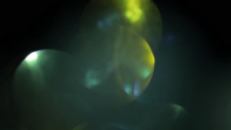 Multicolored-light-leaks-4k-footage-on-black-background.-Stylizing-video,-transitions.-Bokeh-effect