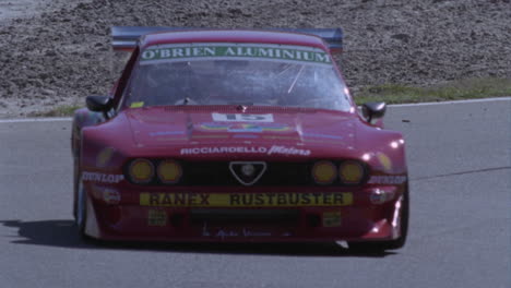 racing car drives on a circuit track