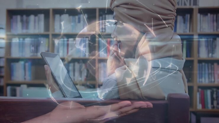 Student tapping tablet in library initiating nodes forming globe above open palm showing connection