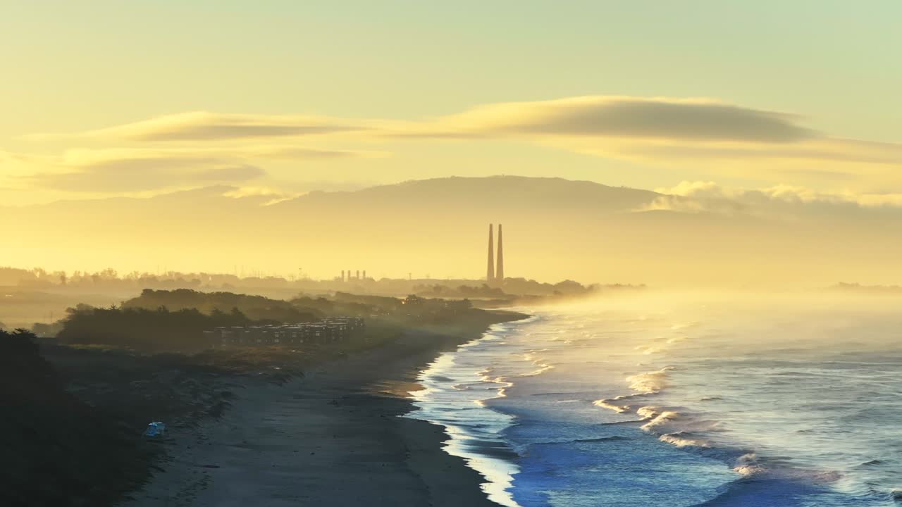 Sunrise over Coastal Power Plant