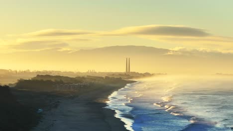sunrise over coastal power plant