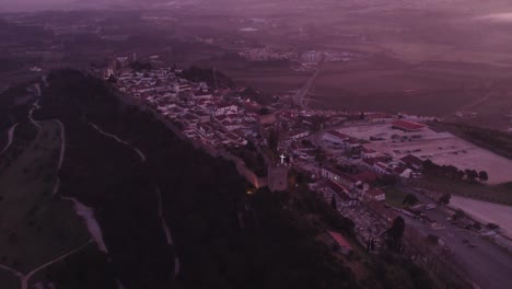 wide shot of medieval town obidos portugal during sunrise, aerial