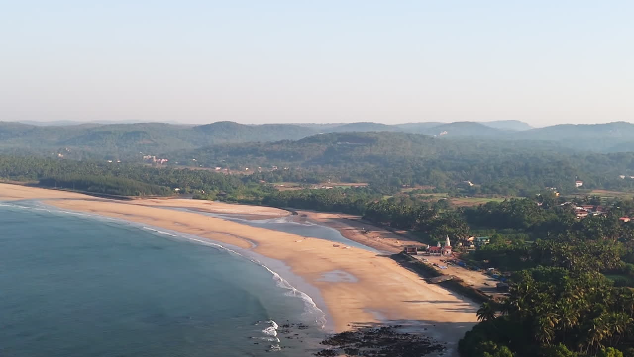 Panoramic drone shot circling the Guhagar beach, sunny morning in India
