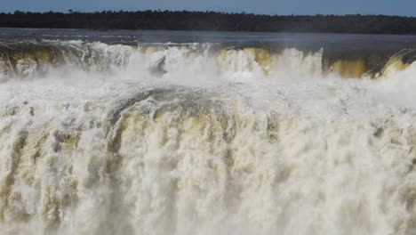 massive flowing water of iguazu waterfalls in the